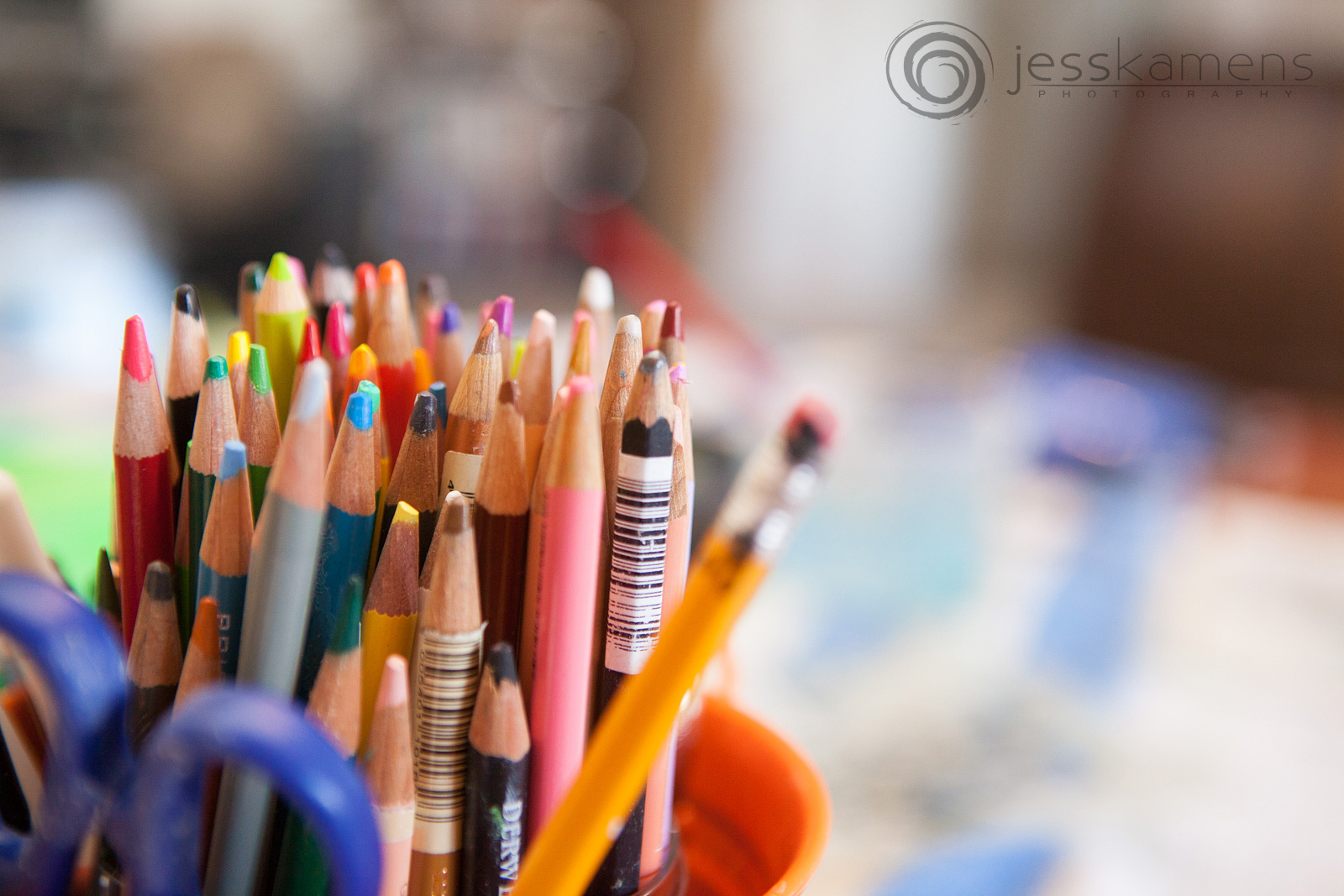 used colored pencils sitting in a container
