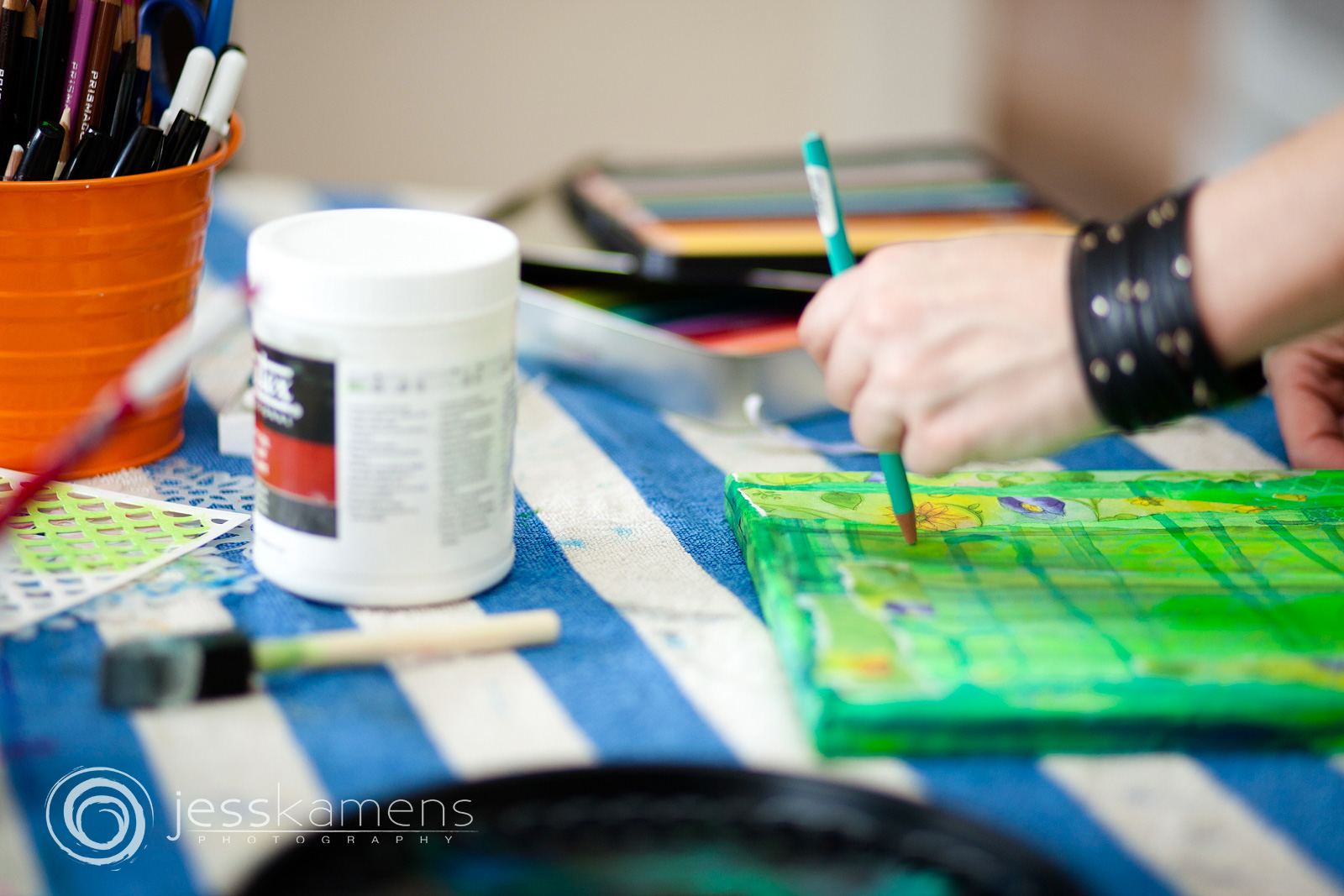 an artist painting a green canvas