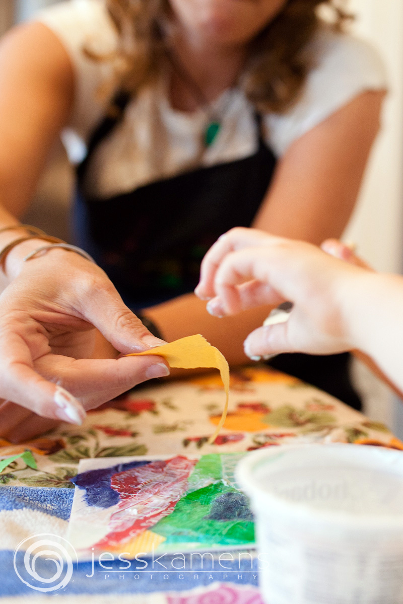 an artist helping a young child learn how to create