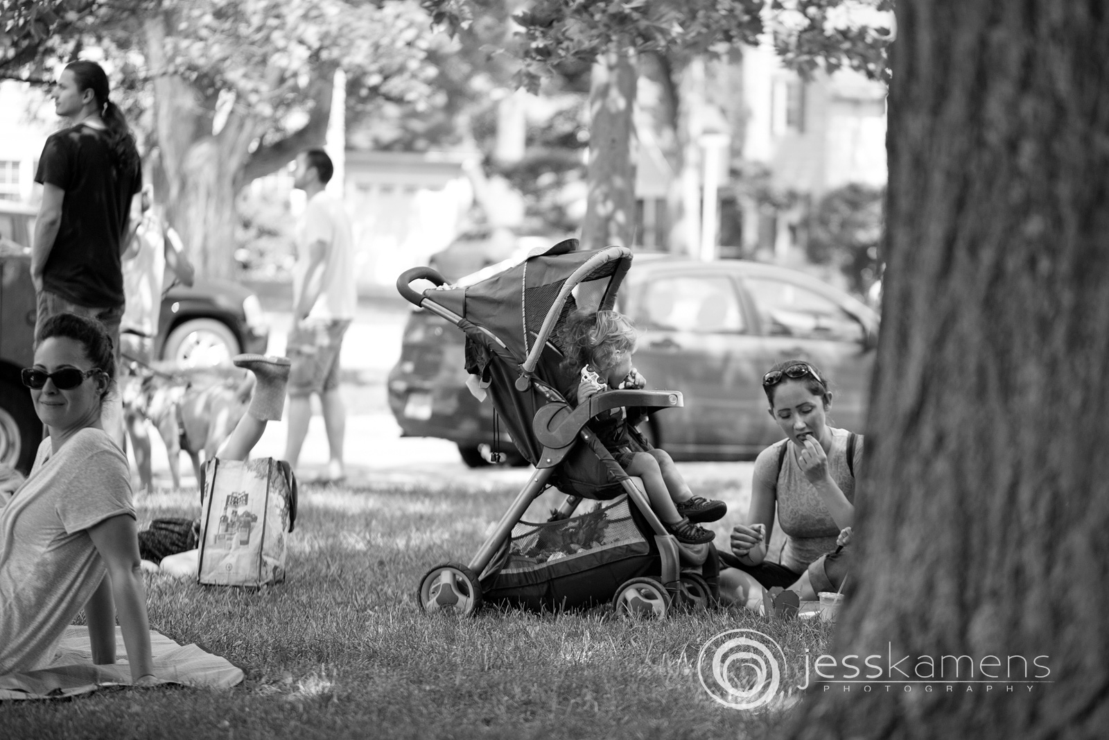 families picnic on the lawn outside of the market