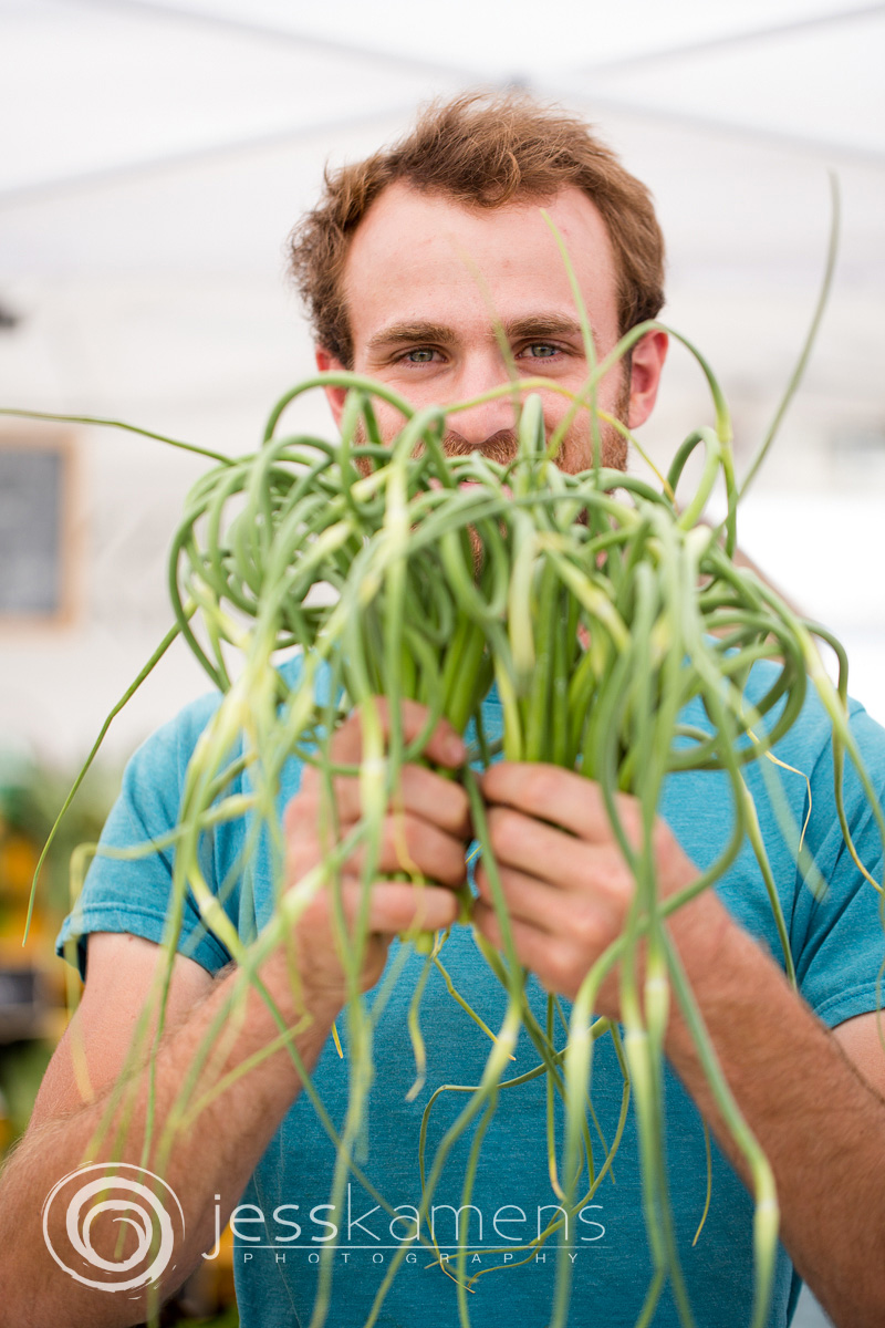 James from Buzz Garden holds up some curly garlic