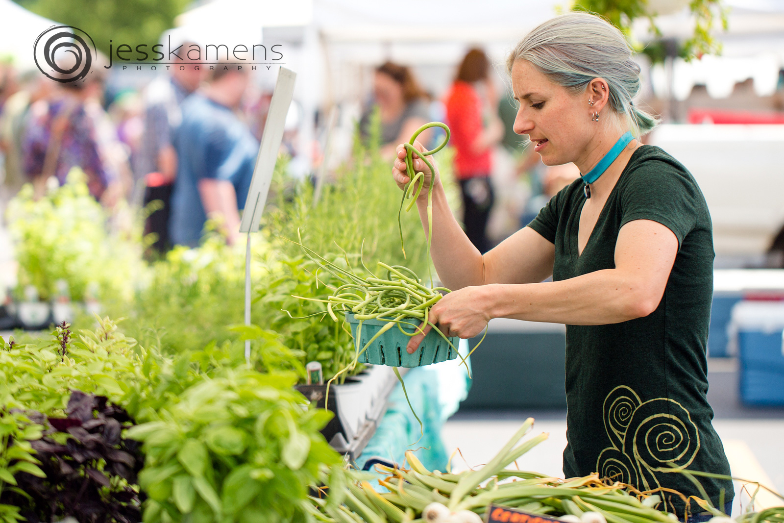 a vendor organizes her garlic