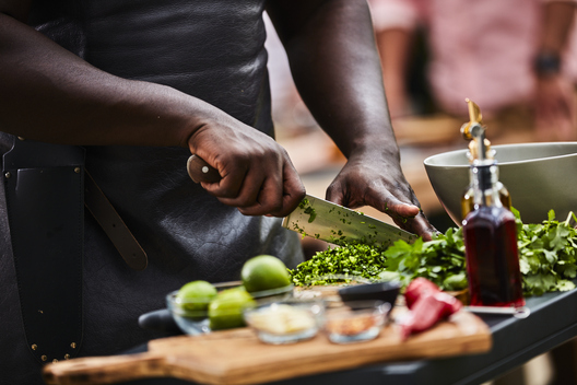 Lifestyle food in action photographed by Jessica Grenier showing a chef plating a dish.