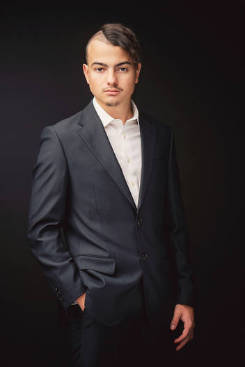 Business headshot of a man on a black backdrop